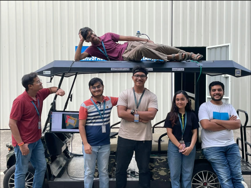 Kaustubh and the project team with the physical autonomous golf cart